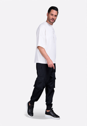 Model wearing white short tassel T-shirt with embroidered detail East Vibe